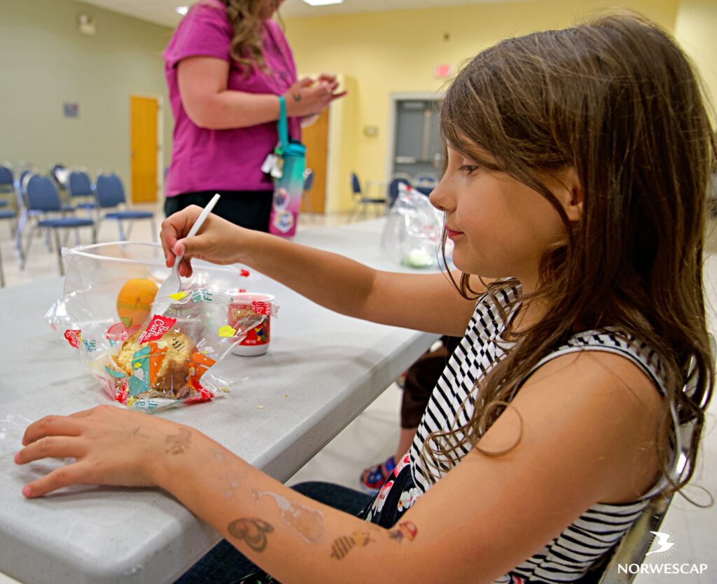 Since 2005, Norwescap has joined hands with the Phillipsburg School District and Maschio's Food Service Company to serve over 3,000 free lunches to children in Phillipsburg each summer. These meals are more than just sustenance; they are a testament to the power of collaboration and compassion. Supported by our partners and the community, these lunches include a delicious variety of healthy options, from crispy chicken wraps to yogurt, bagels with cream cheese, and an abundance of fresh fruits and vegetables. And who could forget the beloved pizza day every Thursday, generously provided by Rocco's Pizzeria!! It is always a day of celebration, reminding us that even in the face of challenges, simple things can bring great joy. 